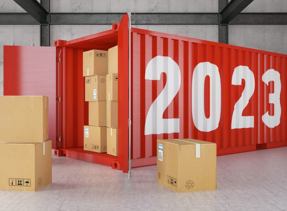 A RED SHIPPING CONTAINER WITH YELLOW 2023 NUMBERS ON ITS SIDE STANDS OPEN