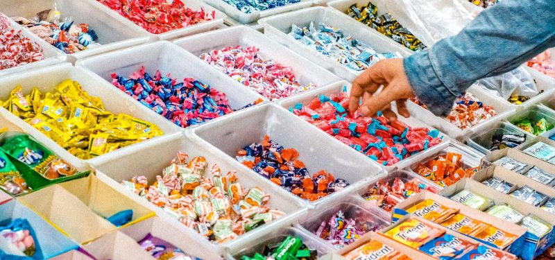 Pick 'n' Mix candy bar with a selection of wrapped candy and gum in white buckets