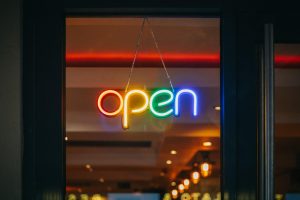 Illumiated multi-color neon open sign in store window 